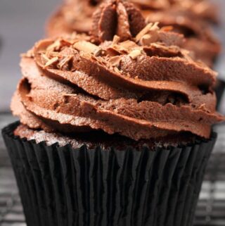 Vegan chocolate cupcakes on a wire cooling rack.