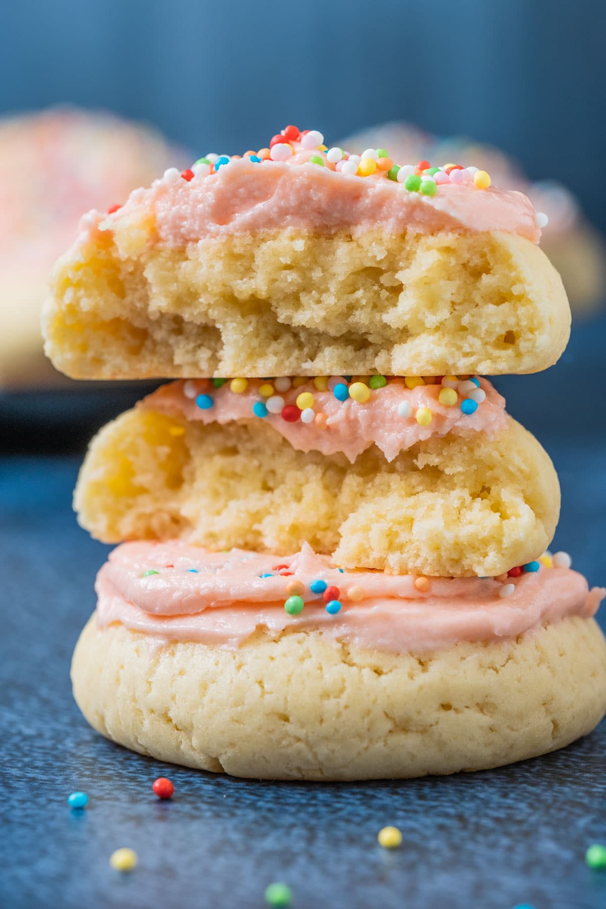 Frosted sugar cookie broken in half.