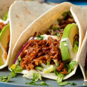 Jackfruit tacos on a gray plate.