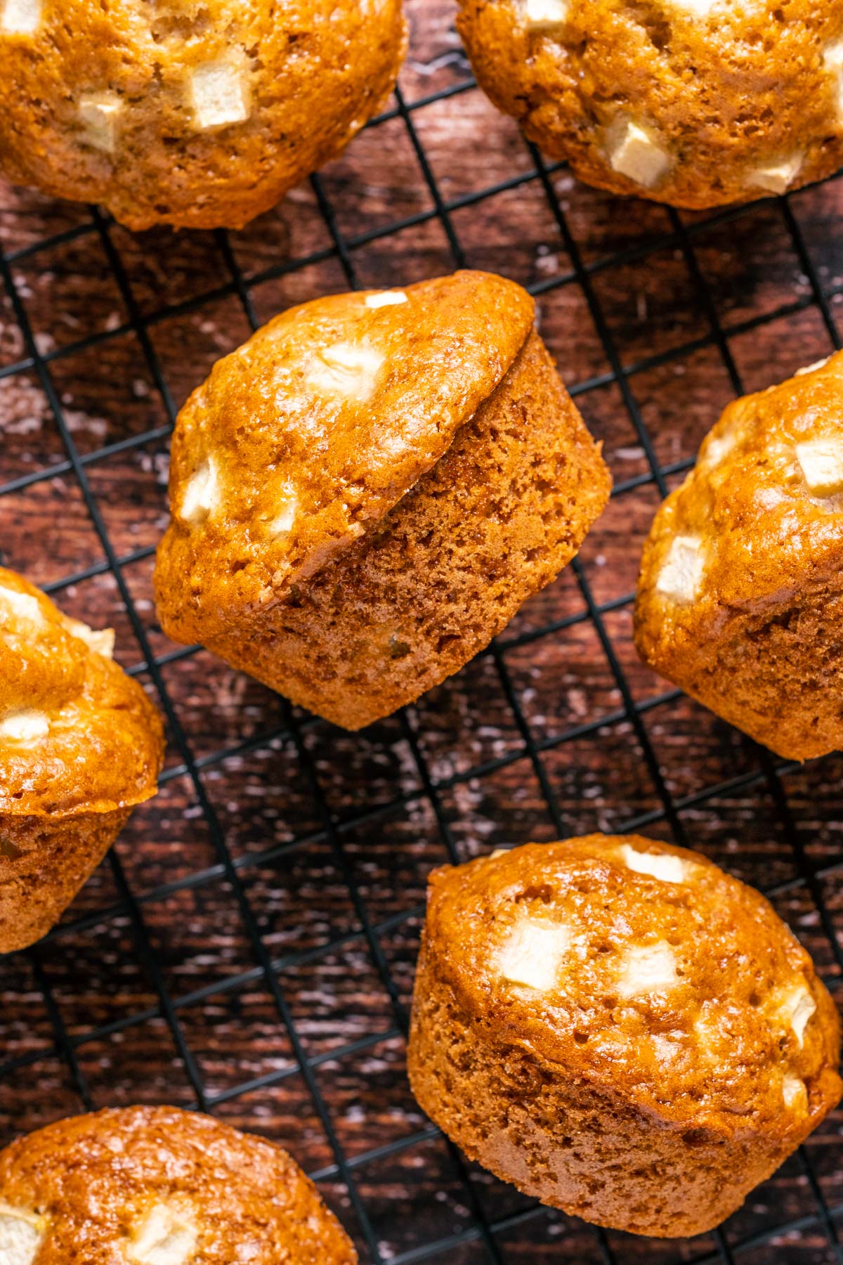 Vegan apple muffins on a wire cooling rack.