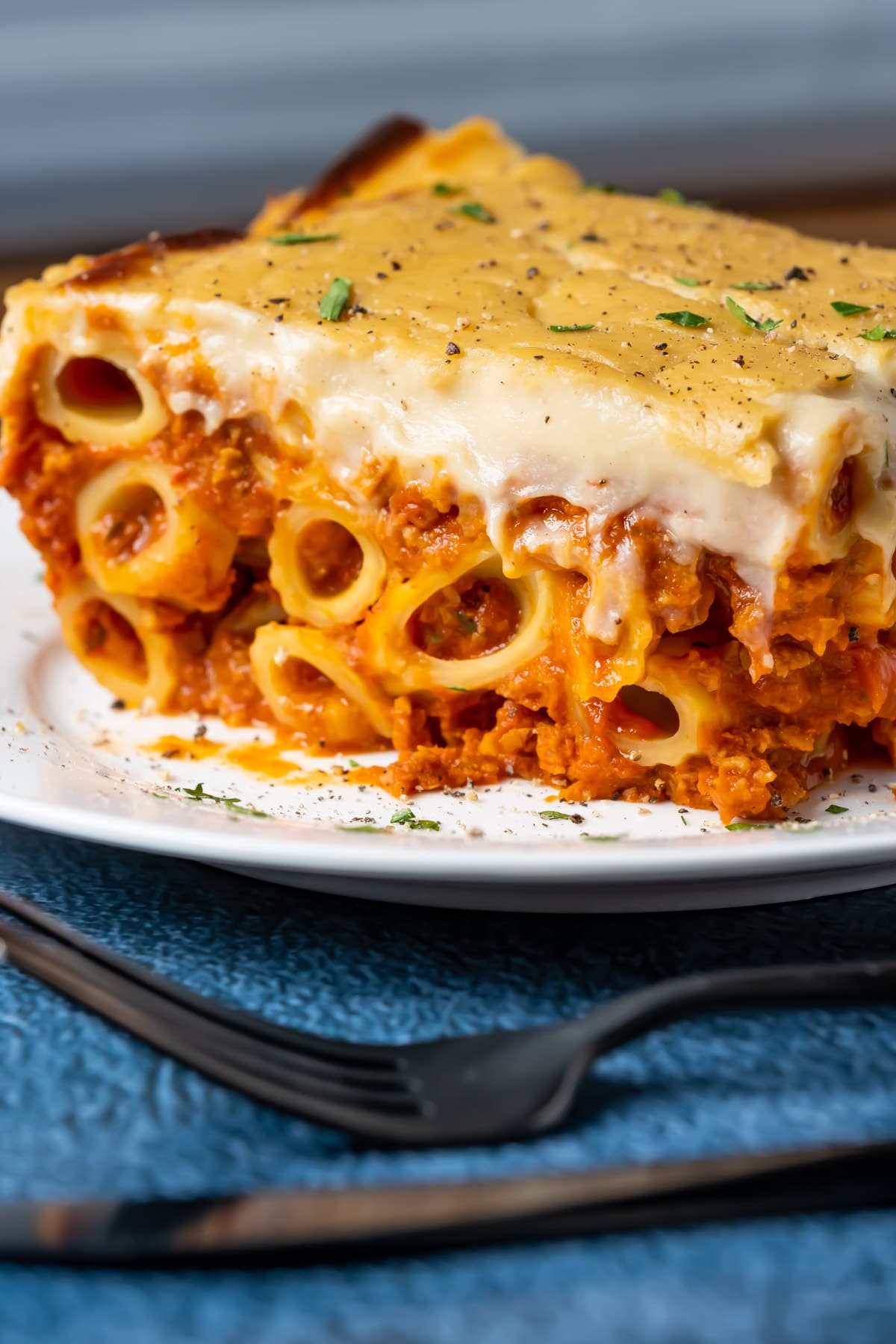 Slice of vegan baked ziti on a white plate.