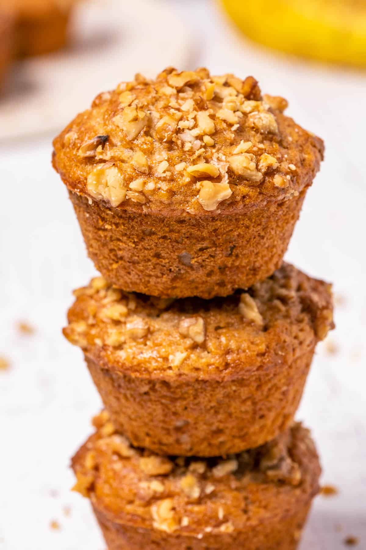 Stack of three vegan banana bread muffins. 