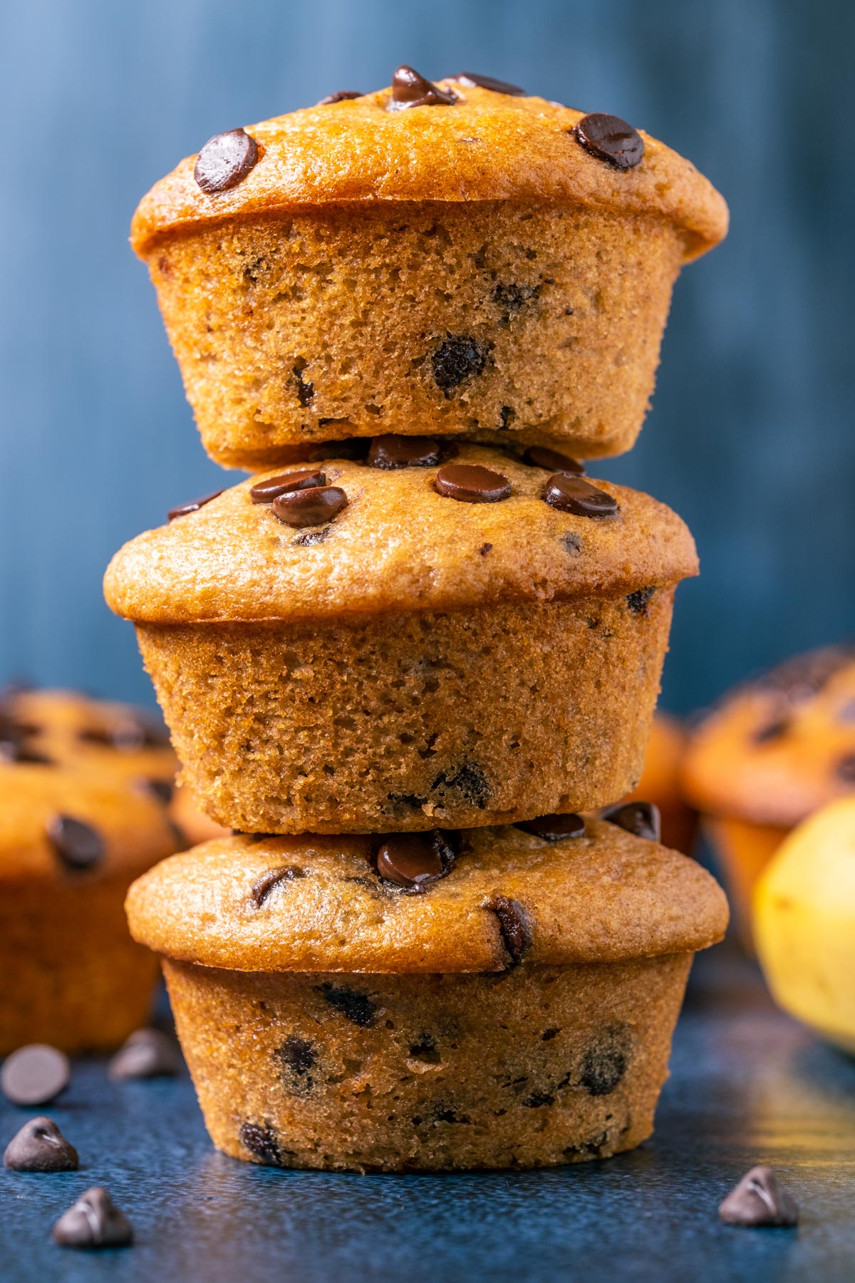 Stack of three vegan banana chocolate chip muffins.