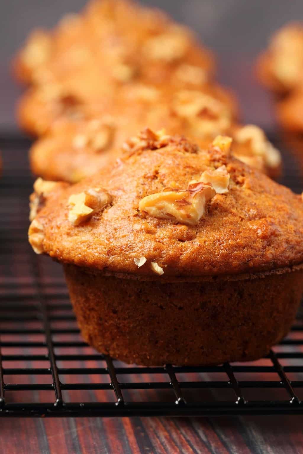 Vegan banana muffins on a wire cooling rack. 