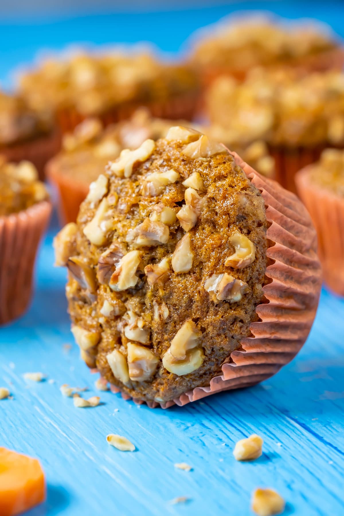 Vegan carrot muffin lying on its side.