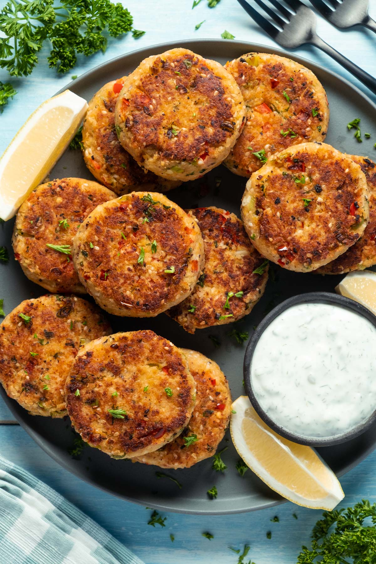 Vegan crab cakes on a plate with tartar sauce. 