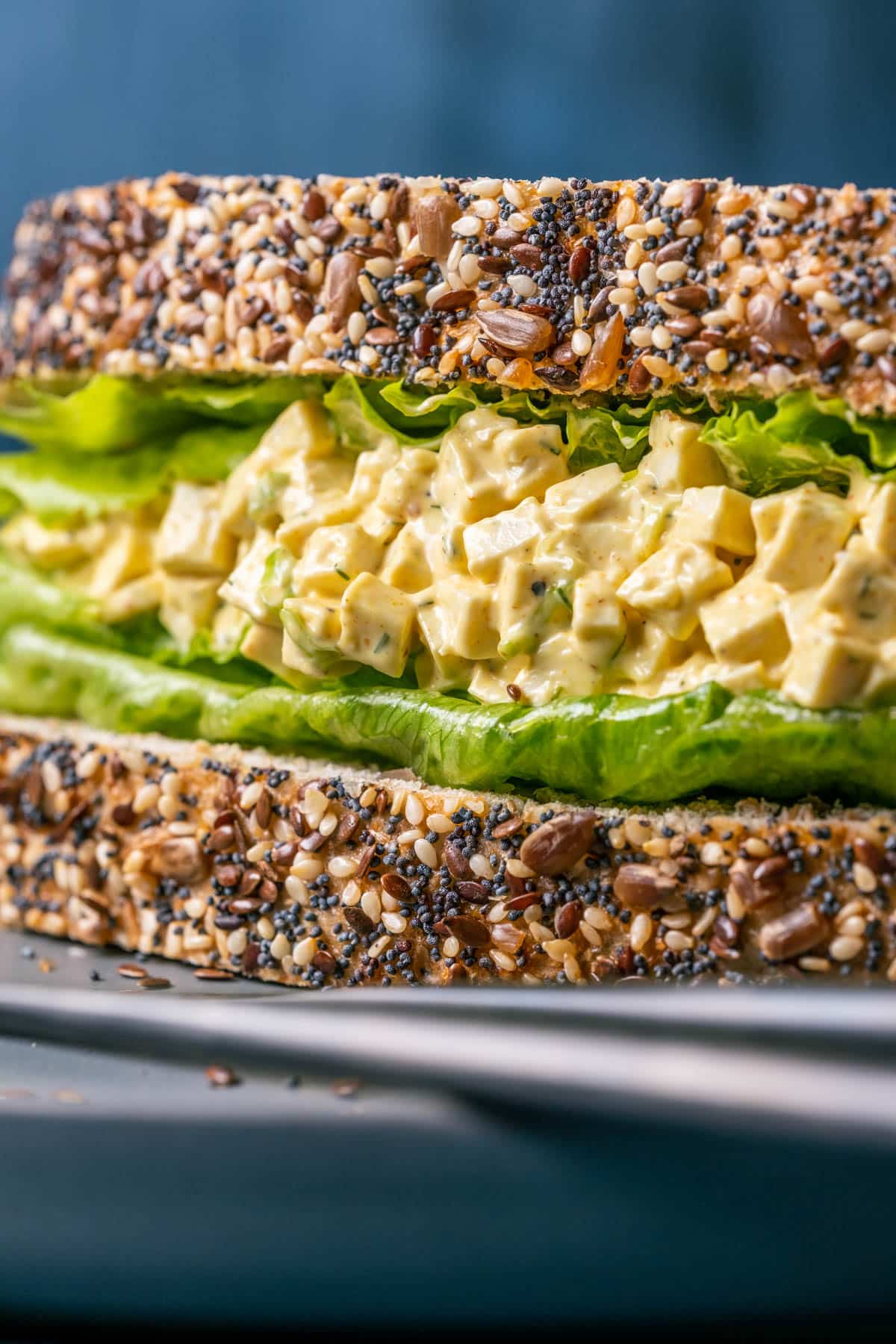 Vegan egg salad sandwich on a gray plate.