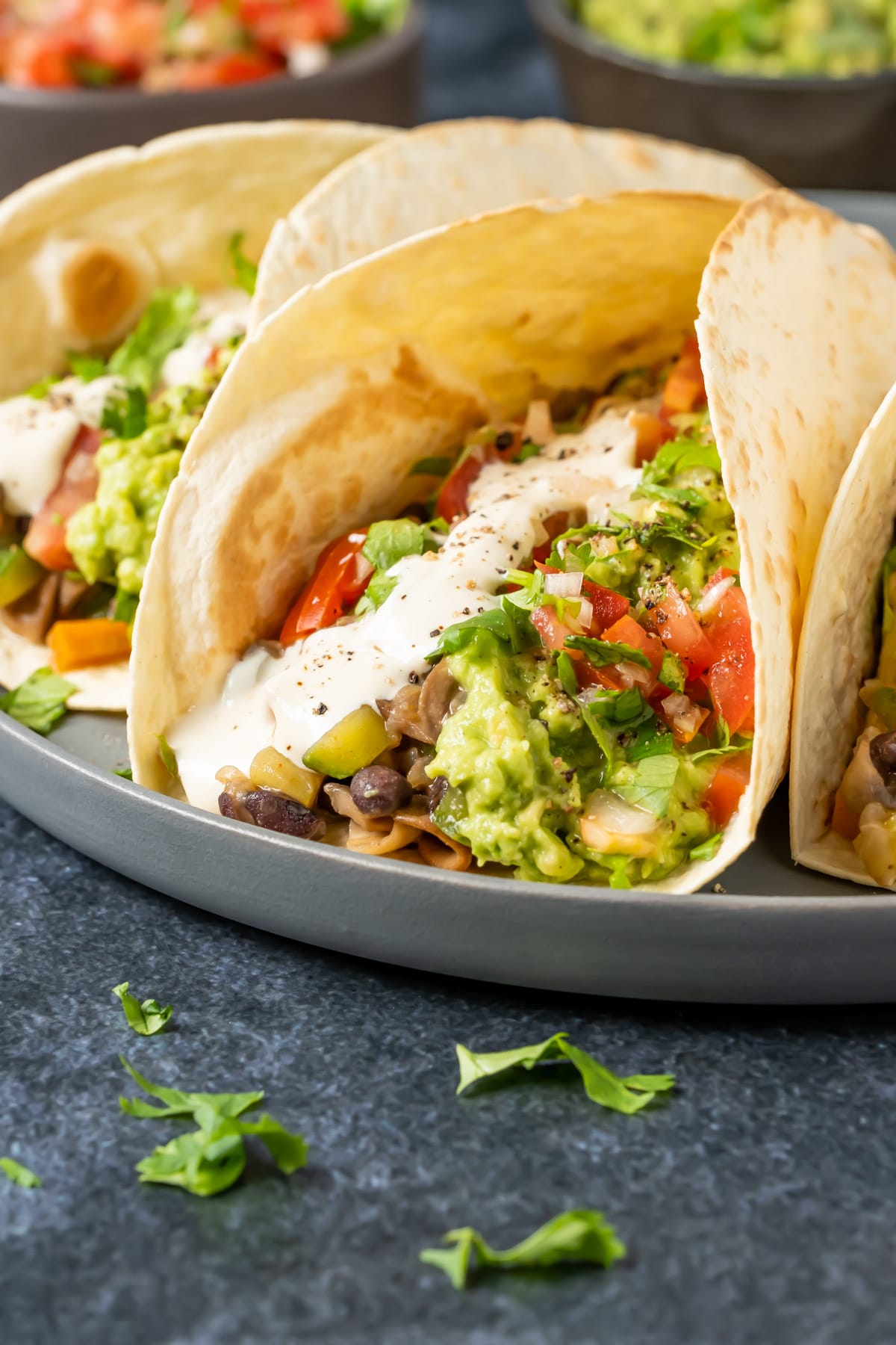 Fully loaded vegan fajitas on a gray plate.