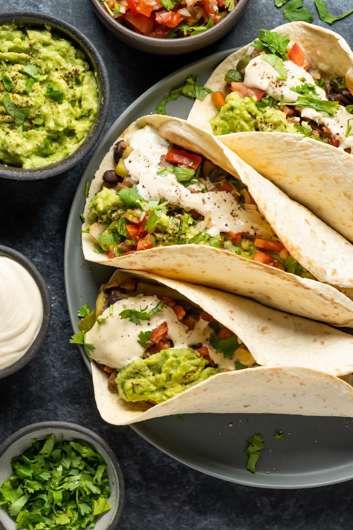 Fully loaded vegan fajitas on a gray plate.