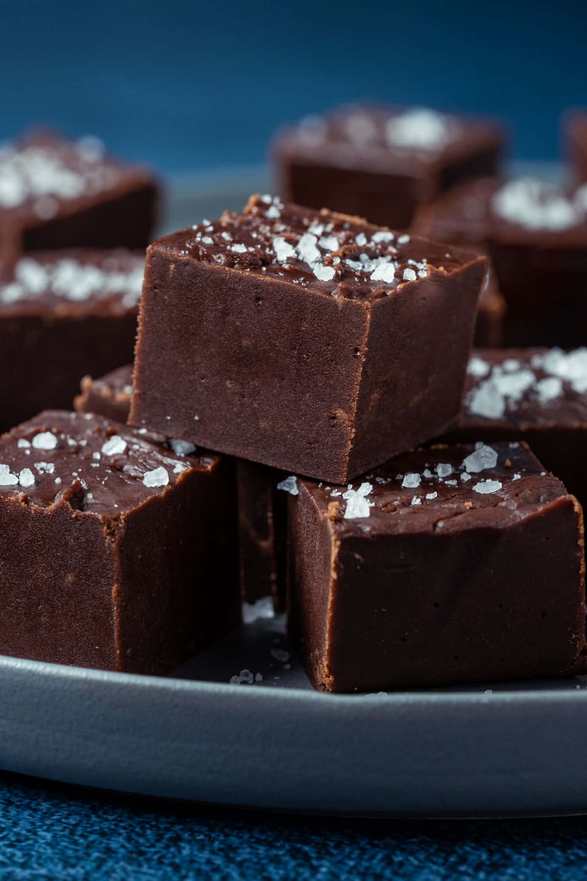 Vegan fudge squares on a gray plate.