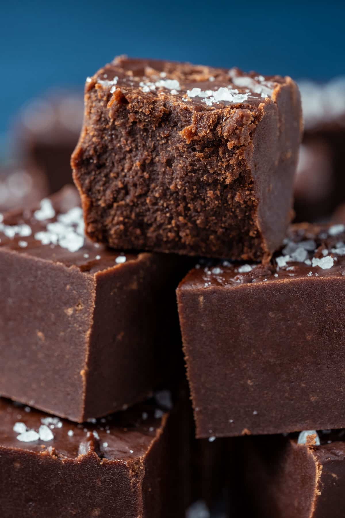 Stack of vegan fudge with the top square broken in half.