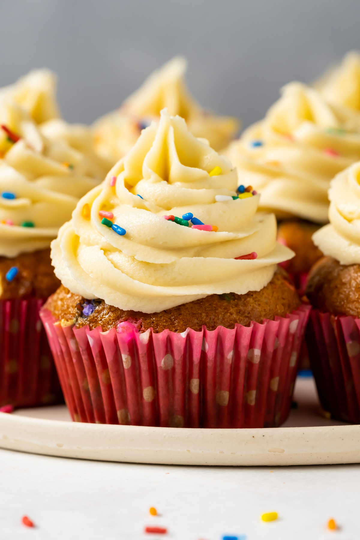 Vegan funfetti cupcakes on a white plate.