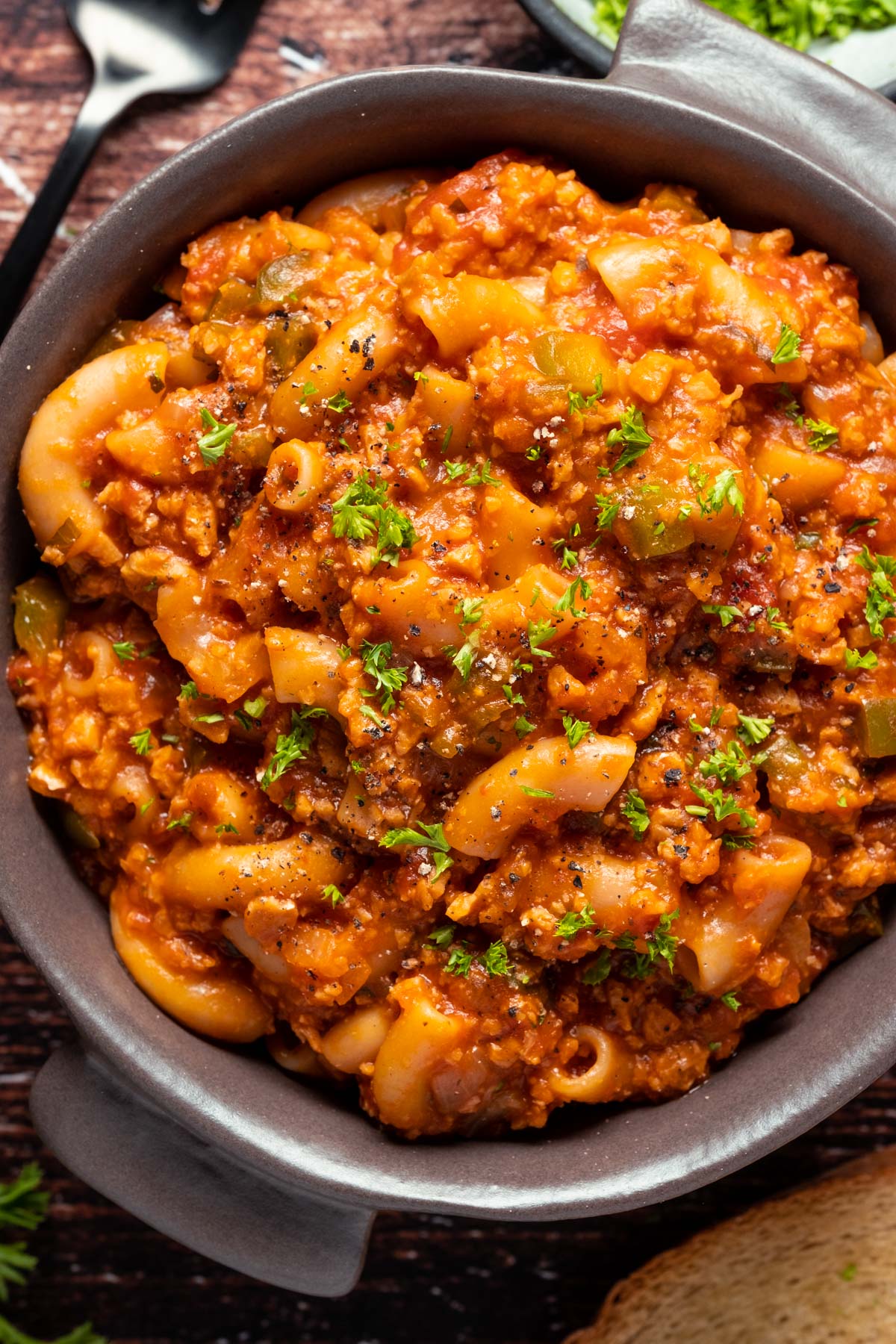 Vegan goulash topped with fresh chopped parsley in a bowl.