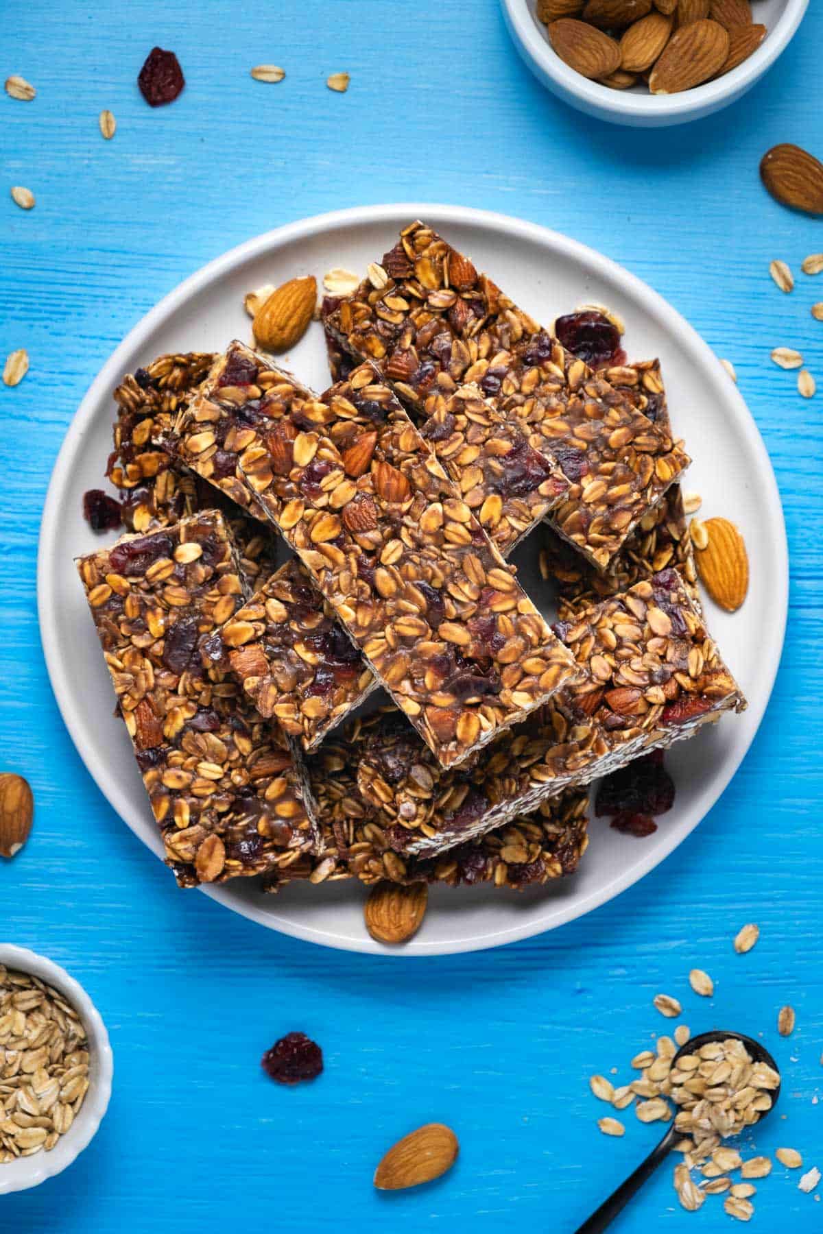 Granola bars stacked up on a white plate. 