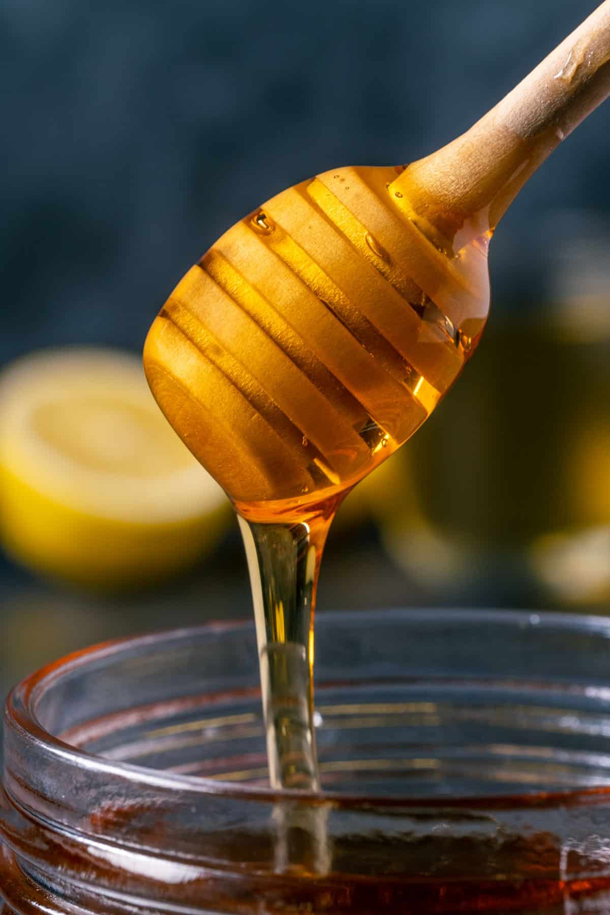 Vegan honey in a jar with a honey dipper.