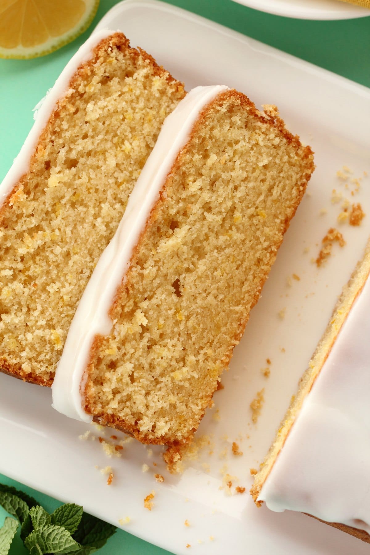 Slices of vegan lemon pound cake on a white plate. 