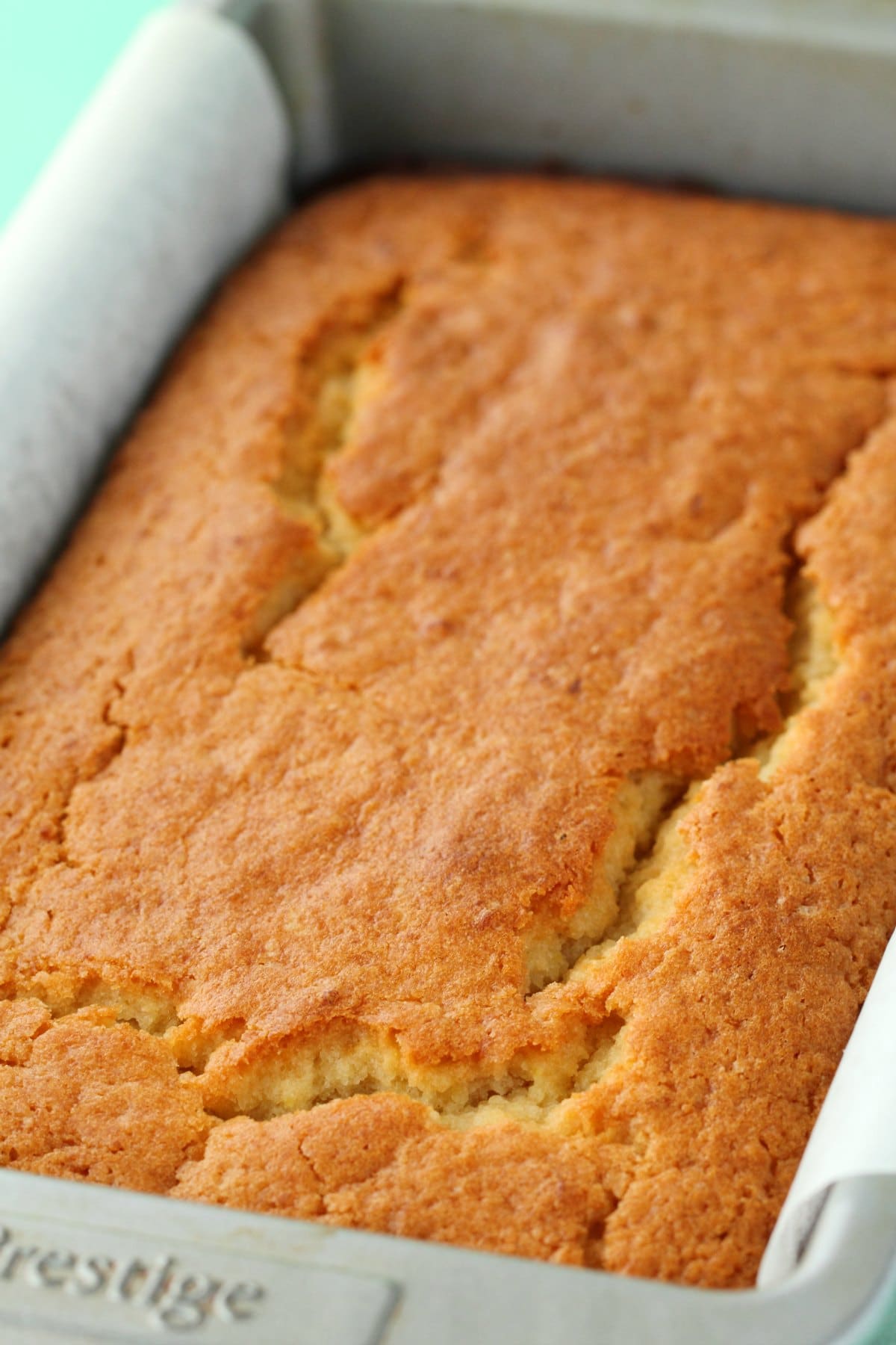 Freshly baked lemon pound cake in a loaf pan. 