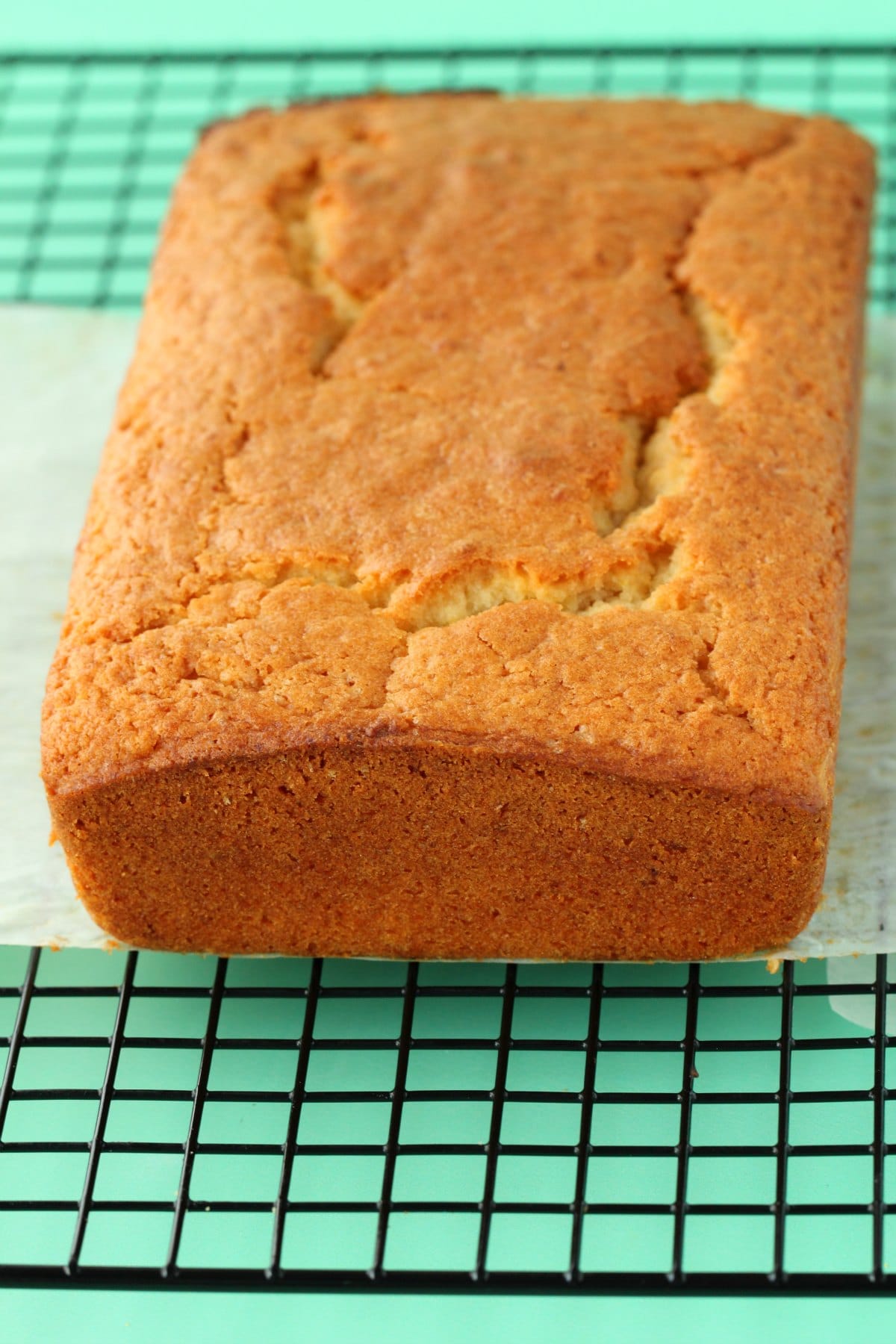 Vegan lemon pound cake on a wire cooling rack. 