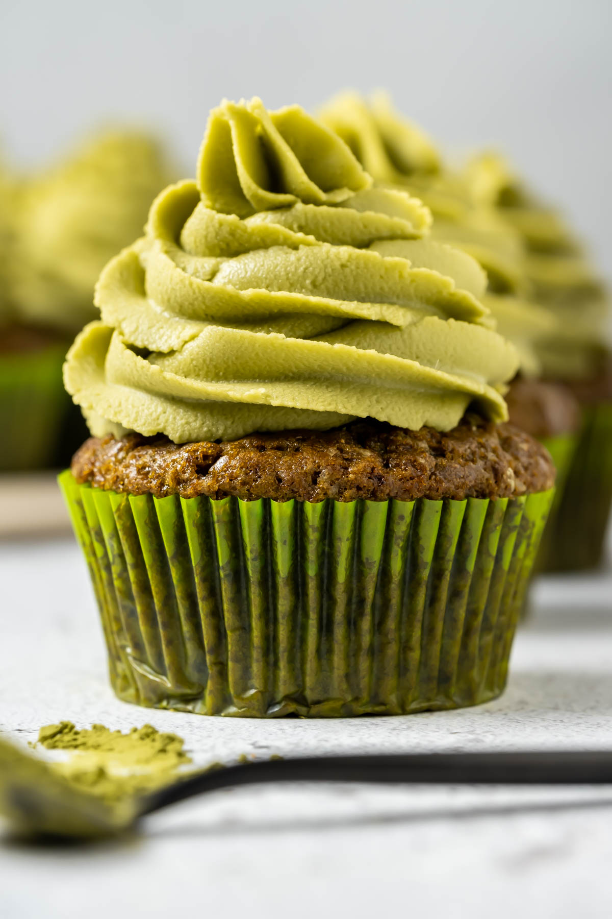 Vegan matcha cupcakes on a white plate. 