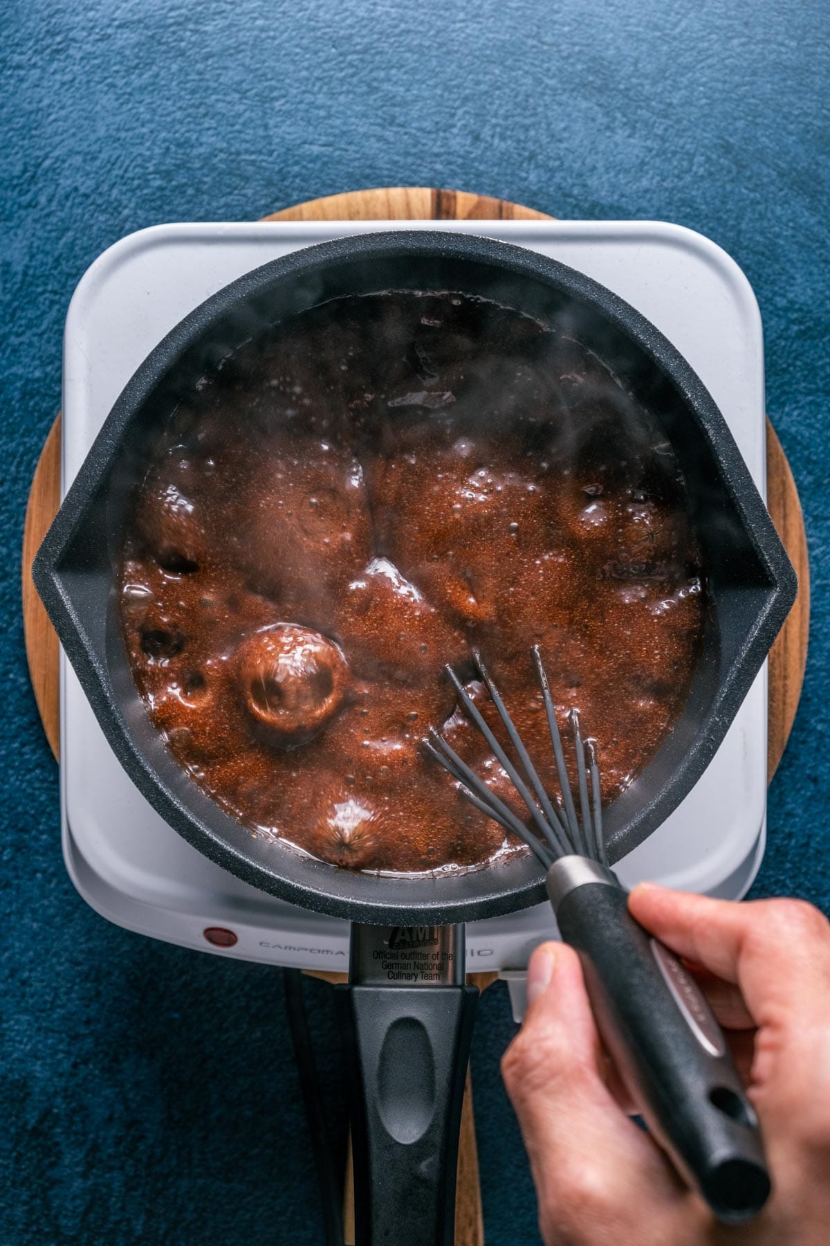 Boiling chocolate mix in a saucepan with a whisk. 