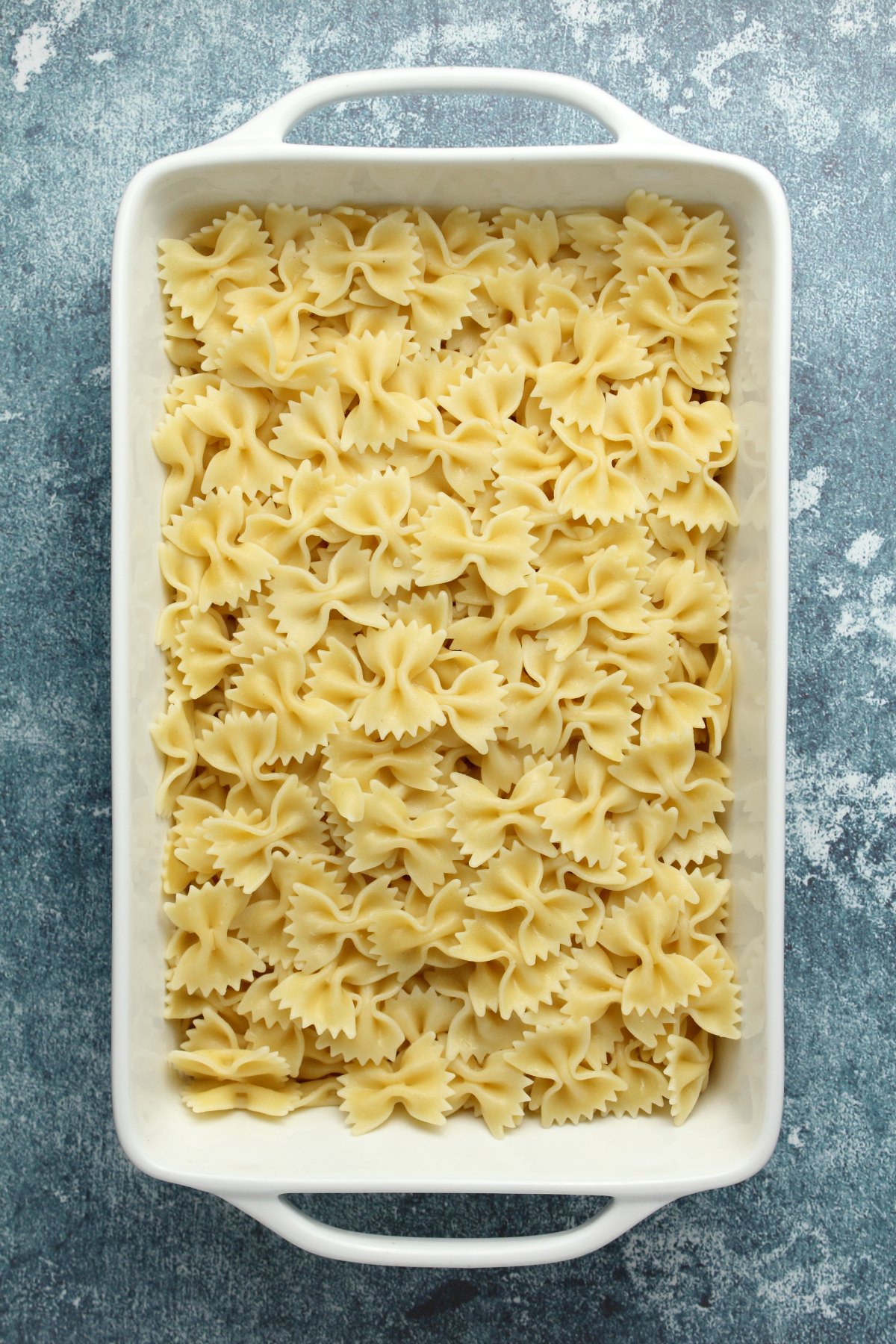 Cooked pasta in a white dish.