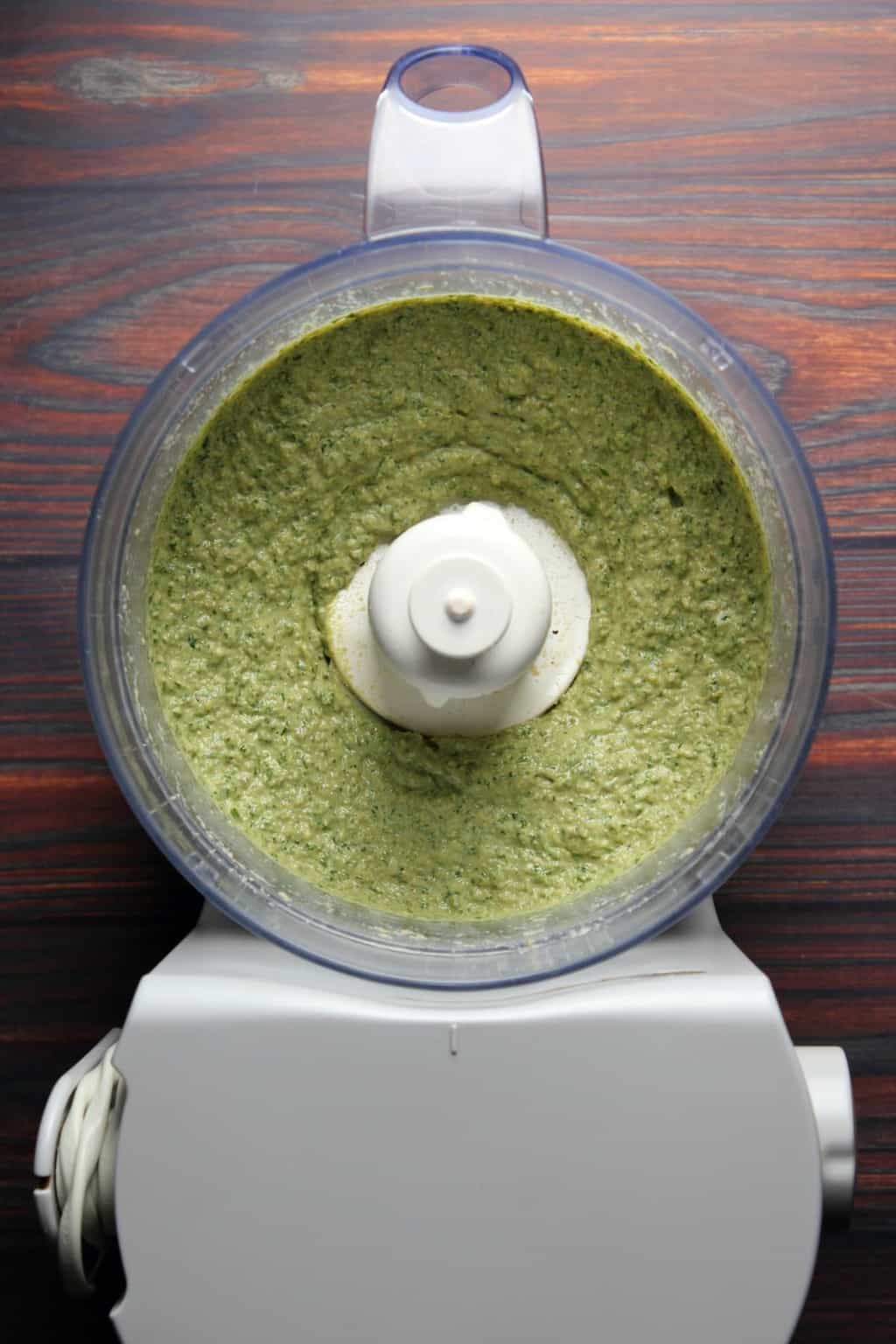 Freshly made vegan pesto in a food processor. 