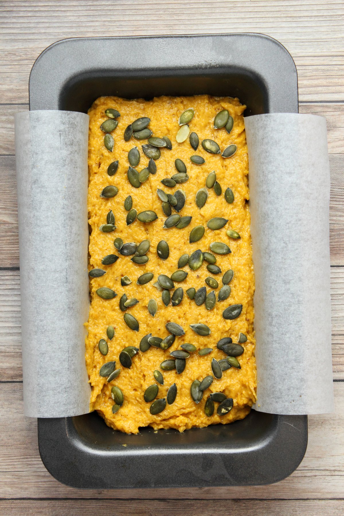 Pumpkin bread batter in a loaf pan ready to go into the oven.