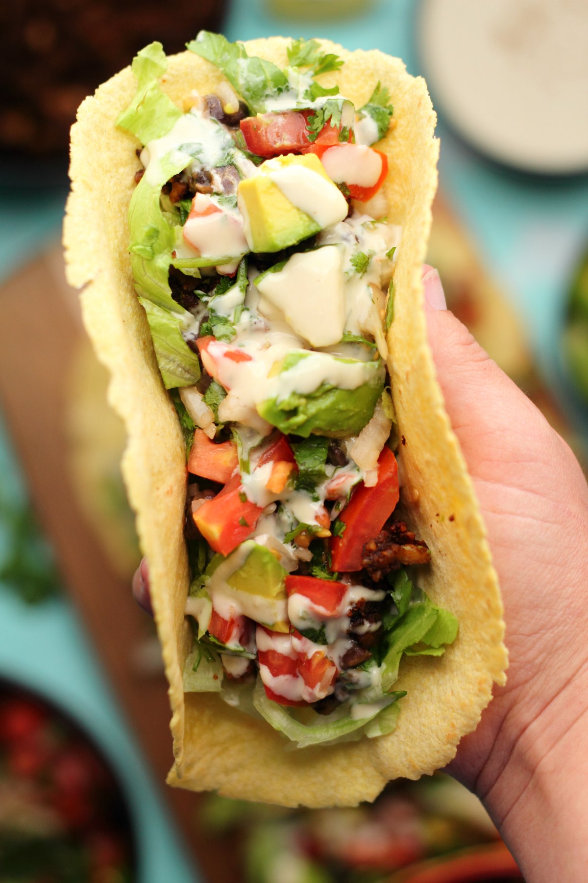 Vegan taco stuffed with black beans, vegan taco meat, pico de gallo, avocado and tahini sauce. 